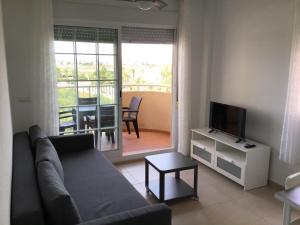 a living room with a couch and a television at La Tortuguita in San Blas