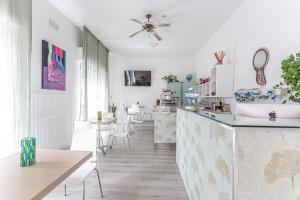 a kitchen and dining room with a counter and chairs at Hotel Lucerna in Cesenatico