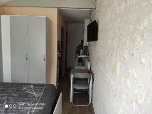 a bedroom with a bed and a desk and a wall at Studio Les Tilleuls in Amboise