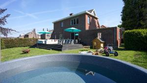 a house with a pool in front of it at SINTPIETER18 @Lo-Ghis vakantiewoning in Voeren