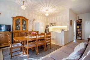 a kitchen and dining room with a table and a couch at Vas Villa in Siófok