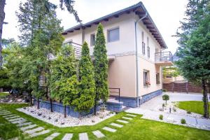 a house with a garden in front of it at Vas Villa in Siófok