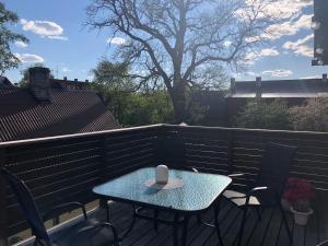 a table and chairs on a patio with a cup on it at Lille Lux Apartment in Viljandi