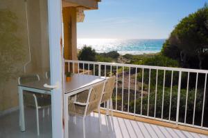 a balcony with a table and a view of the ocean at Apartments Es Trenc in Ses Covetes