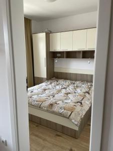 um quarto com uma cama grande e armários brancos em Aivazovski park - Pomorie SP apartments em Pomorie