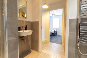 a bathroom with a shower and a sink and a mirror at Orchard Point in Southampton