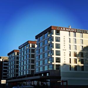 a building with a sign on top of it at Armoni Deluxe Suites Trabzon in Trabzon