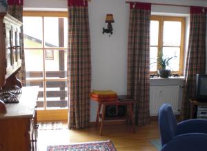 a living room with curtains on the windows at Ferienwohnung Ernst in Berchtesgaden