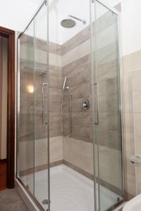 a shower stall with a glass door in a bathroom at Casa di Dario in Diano dʼAlba +30 photos