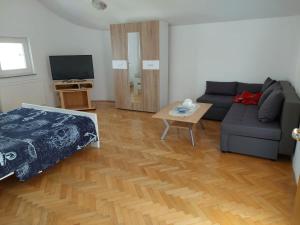 a living room with a couch and a table at Apartments "Jope i Toni" in Biograd na Moru