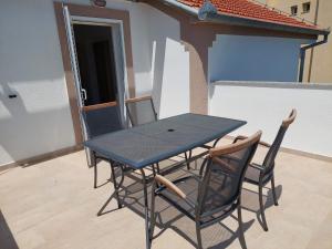 a table and two chairs sitting on a balcony at Apartments "Jope i Toni" in Biograd na Moru