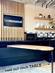a counter with a table with a sign on it at beminimal parques in Medellín