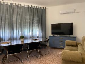 a living room with a table and a tv at CASA DEL DELTA in Sant Jaume d'Enveja