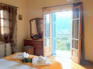 a bedroom with a bed and a mirror and a door at TWO SEAS in Stavros