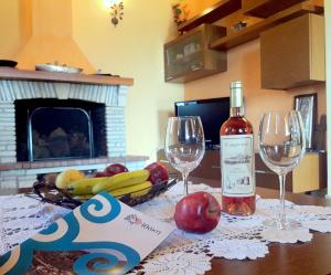 a bottle of wine and two wine glasses on a table at TWO SEAS in Stavros