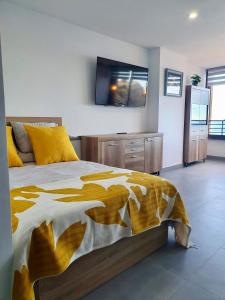 a bedroom with a bed with a television on the wall at Playa Poniente Benidorm in Benidorm