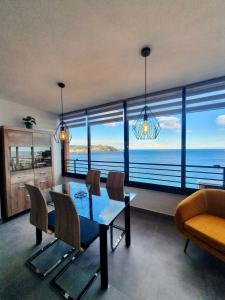 a dining room with a view of the ocean at Playa Poniente Benidorm in Benidorm