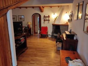 a living room with a wooden floor and a fireplace at Stefano Home Abetone in Abetone