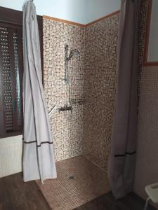 a bathroom with a shower with a shower curtain at Alojamientos Rurales La Esperanza in Arriate