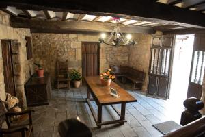 a room with a wooden table in a building at La torrevia2 in Santillana del Mar