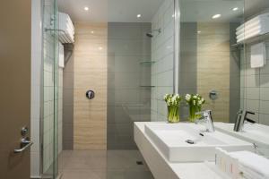 a bathroom with a sink and a shower at Rydges Auckland in Auckland