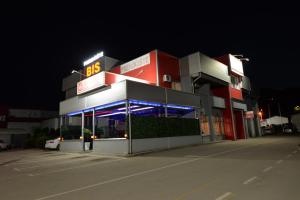 a building with a gas station at night at Prenoćište Bis in Prijepolje