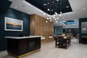 a restaurant lobby with a cut counter and tables at Rydges Auckland in Auckland