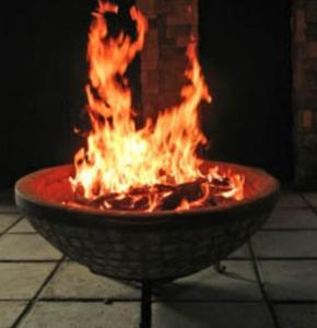 a fire in a fire pit with flames in it at La Dolce Vita Apartments Unit 2 in Posedarje