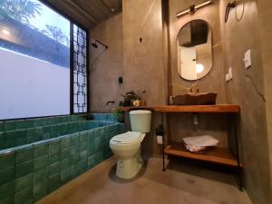 a bathroom with a toilet and a sink and a tub at Nido Sky in Medellín