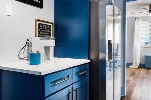 a blue and white kitchen with a blue wall at 2208-Top Flr-Work/Game Sta-600 MB-1 Free Park-King in Atlanta