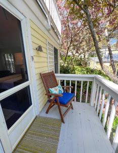a porch with a wooden chair on a house at Inn at Cook Street in Provincetown