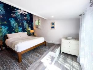 a bedroom with a bed and a painting on the wall at Inn at Cook Street in Provincetown