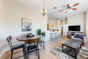 a dining room and living room with a table and chairs at Placita Escondida #205 in Tucson