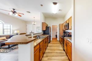 a kitchen with wooden cabinets and a counter top at Placita Escondida #205 in Tucson