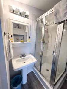 a bathroom with a sink and a shower at Inn at Cook Street in Provincetown
