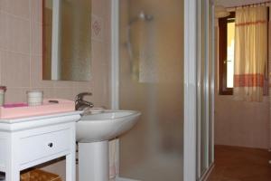 a bathroom with a white sink and a shower at Casa Roberta in Alghero +21 photos