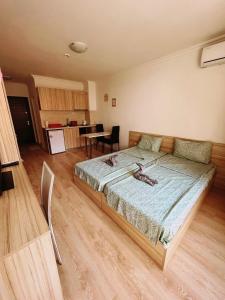 a bedroom with a large bed in a room at Lovely studio apartment on the beach in Burgas City