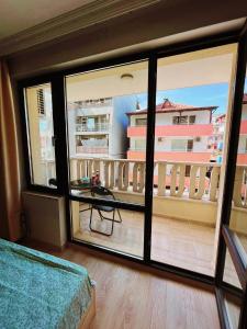 a room with a view of a balcony at Lovely studio apartment on the beach in Burgas City