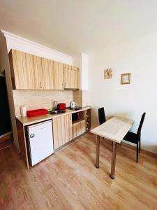 a kitchen with a table and a table and a dining room at Lovely studio apartment on the beach in Burgas City