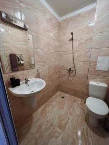 a bathroom with a toilet and a sink at Lovely studio apartment on the beach in Burgas City