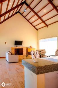 a living room with a fireplace and a tv at HOP OHANA exclusiva en campo y playa en Chincha in Chincha Baja