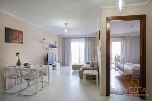 a white living room with a table and a couch at Park View City Apartment, Vesta Philoxenia in Thessaloniki