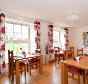 a dining room with tables and chairs and a window at The Rocks B&B in Crumlin