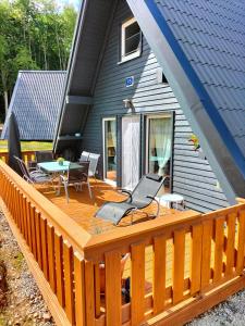 a deck with a table and chairs on a house at Ferienhaus Joschko in Bad Arolsen