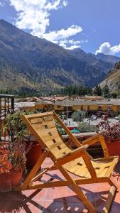a wooden chair sitting on top of a patio at Los Apus Ollantaytambo in Cusco
