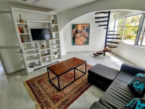 a living room with a couch and a table at casa HIKURI in Cancún