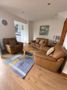 a living room with two couches and a rug at Pure Apartments Fife - Dunfermline West in Oakley