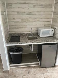 a kitchen counter with a sink and a microwave at The Atlantic in Myrtle Beach