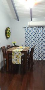 a dining room with a table with chairs and a wreath at Breezy Nights St. Croix in Christiansted