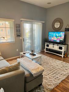 a living room with a couch and a tv at LUX! 2 bd 2 ba Farmhouse condo Mesa/Phoenix metro in Mesa